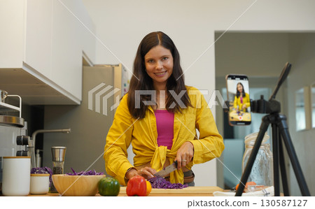 Young woman is broadcasting live from workshop how to prepare a vegetarian food 130587127