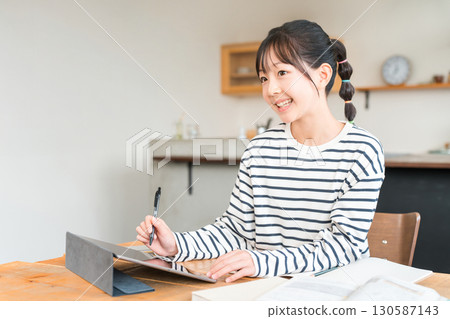 Elementary and junior high school girls studying and doing homework using tablets 130587143