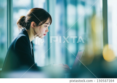 Japanese businesswoman shining in a big city office Japanese businesswoman shining in a big city office 130587164