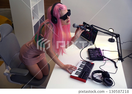 Beautiful young singer and musician broadcast from her home studio 130587218