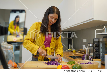 Young woman is broadcasting live from workshop how to prepare a vegetarian food 130587340