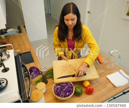 Young woman is broadcasting live from workshop how to prepare a vegetarian food Young woman is broadcasting live from workshop how to prepare a vegetarian food 130587488