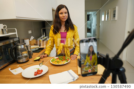 Young woman is broadcasting live from workshop how to prepare a vegetarian food 130587490