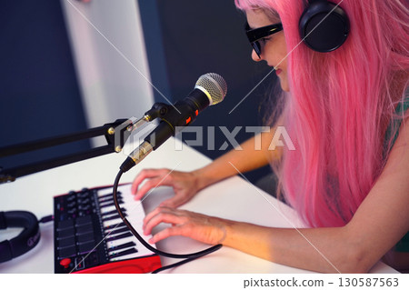 Beautiful young singer and musician broadcast from her home studio 130587563