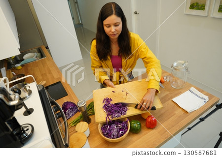Young woman is broadcasting live from workshop how to prepare a vegetarian food Young woman is broadcasting live from workshop how to prepare a vegetarian food 130587681