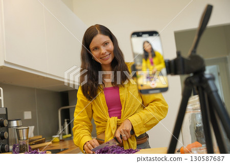 Young woman is broadcasting live from workshop how to prepare a vegetarian food 130587687