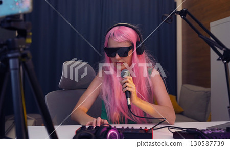 Beautiful young singer and musician broadcast from her home studio 130587739