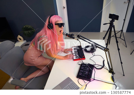 Beautiful young singer and musician broadcast from her home studio 130587774