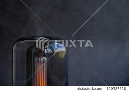 Home fragrance aromatic diffuser with essential oil. Modern air humidifier at home. Improving the comfort of wellbeing living in house. Ultrasonic aroma perfume steam 130587838