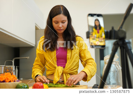 Young woman is broadcasting live from workshop how to prepare a vegetarian food 130587875
