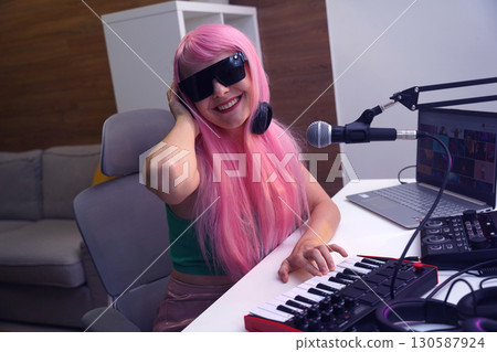 Beautiful young singer and musician broadcast from her home studio Beautiful young singer and musician broadcast from her home studio 130587924