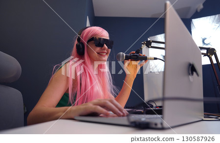 Beautiful young singer and musician broadcast from her home studio 130587926