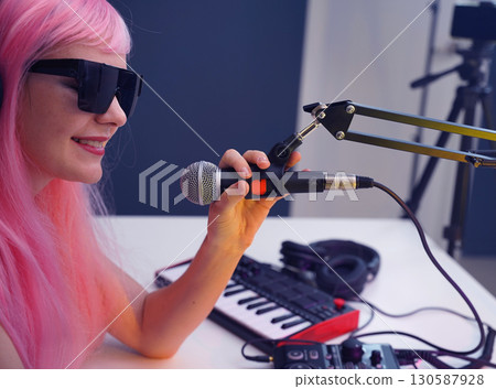 Beautiful young singer and musician broadcast from her home studio 130587928