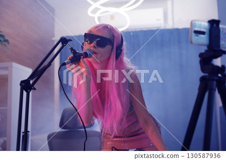 Beautiful young singer and musician broadcast from her home studio Beautiful young singer and musician broadcast from her home studio 130587936