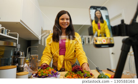 Young woman is broadcasting live from workshop how to prepare a vegetarian food 130588168