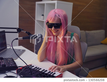 Beautiful young singer and musician broadcast from her home studio Beautiful young singer and musician broadcast from her home studio 130588208