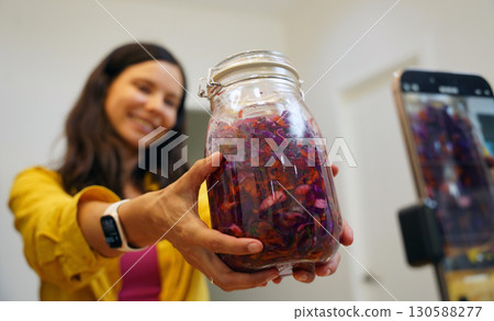 Young woman is broadcasting live from workshop how to prepare a vegetarian food Young woman is broadcasting live from workshop how to prepare a vegetarian food 130588277