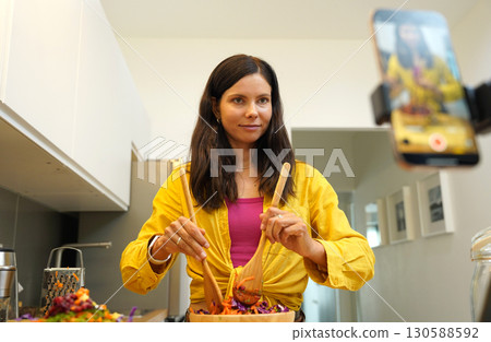 Young woman is broadcasting live from workshop how to prepare a vegetarian food 130588592