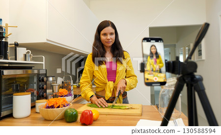 Young woman is broadcasting live from workshop how to prepare a vegetarian food 130588594