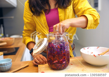 Young woman is broadcasting live from workshop how to prepare a vegetarian food Young woman is broadcasting live from workshop how to prepare a vegetarian food 130588597