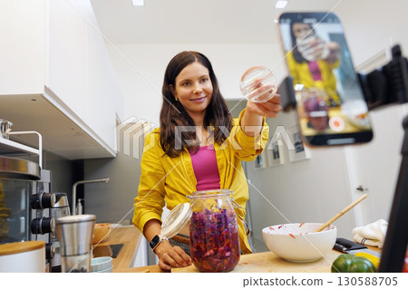 Young woman is broadcasting live from workshop how to prepare a vegetarian food 130588705