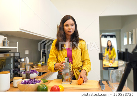 Young woman is broadcasting live from workshop how to prepare a vegetarian food 130588725