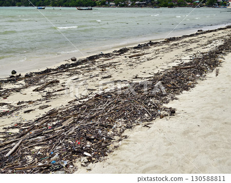 A beach heavily littered with wood and plastic A beach heavily littered with wood and plastic 130588811