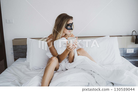 Sexy nude young woman with black mask posing in the bedroom 130589044