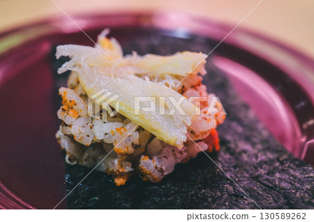 Sushi Rice and Toppings on a Dark Seaweed Wrap 130589262