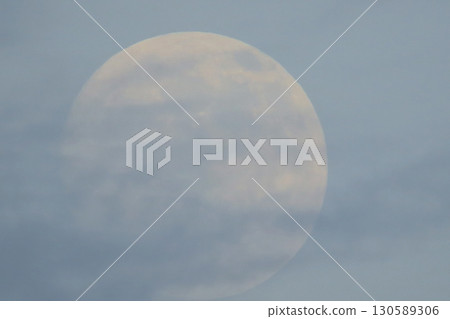 Full Moon with Gentle Clouds in a Soft Sky During Evening Twilight Full Moon with Gentle Clouds in a Soft Sky During Evening Twilight 130589306