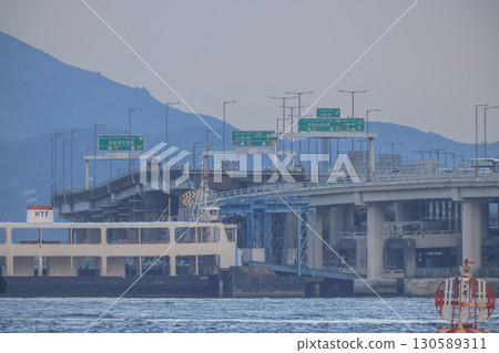 Sept 6 2025 Elevated Highway With Mountains and Traffic Signs Under Overcast Sky 130589311