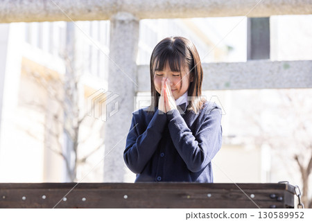 Students in uniform praying for success 130589952
