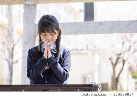 Students in uniform praying for success 130589954