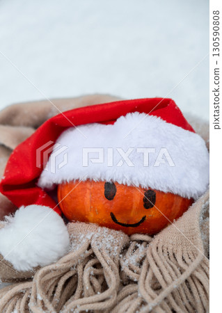 Funny orange pumpkin with smile and eyes in Santa's hat in snowy background. Creative concept of sharp cooling in autumn. Climate change. Sustainable responsible Christmas Funny orange pumpkin with smile and eyes in Santa's hat in snowy background. Creative concept of sharp cooling in autumn. Climate change. Sustainable responsible Christmas 130590808