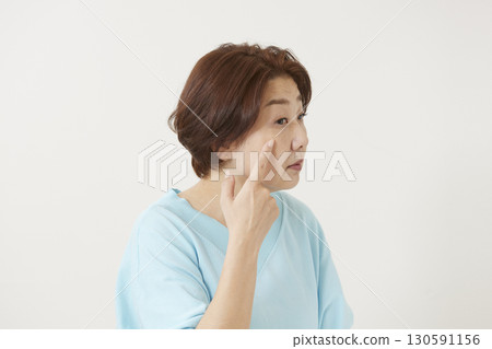 Senior women who are concerned about spots and wrinkles Senior women who are concerned about spots and wrinkles 130591156