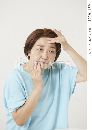 Senior women who are concerned about spots and wrinkles 130591179