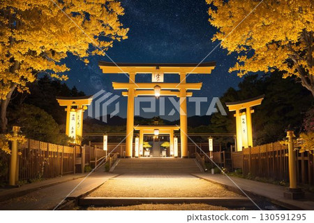 A golden torii gate and a fantastic night view 130591295