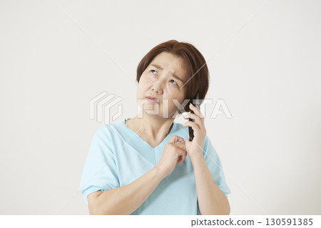Senior woman operating a smartphone Senior woman operating a smartphone 130591385