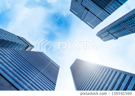 Low angle view of skyscrapers modern office building city in business center with blue sky Low angle view of skyscrapers modern office building city in business center with blue sky 130591560