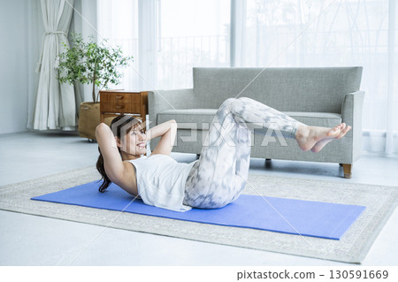 Young woman training at home Young woman training at home 130591669