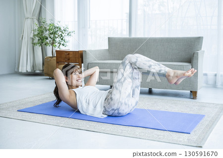 Young woman training at home Young woman training at home 130591670