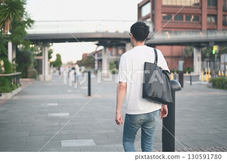 Rear view of a man walking in the city 130591780