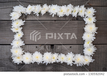 White Flowers Frame on Wooden Surface. Top View Photo. Wallpaper Background Template. White Flowers Frame on Wooden Surface. Top View Photo. Wallpaper Background Template. 130592042
