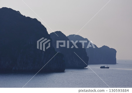 The strange rock formations of Halong Bay, shrouded in mist, look like ink paintings The strange rock formations of Halong Bay, shrouded in mist, look like ink paintings 130593884