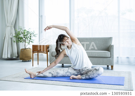 Young woman training at home Young woman training at home 130593931