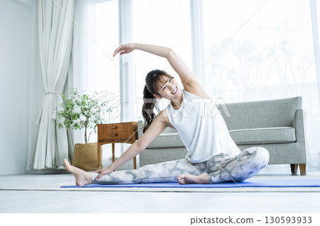 Young woman training at home Young woman training at home 130593933