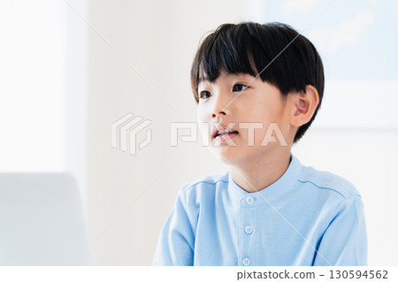 A boy taking a class in front of a computer A boy taking a class in front of a computer 130594562