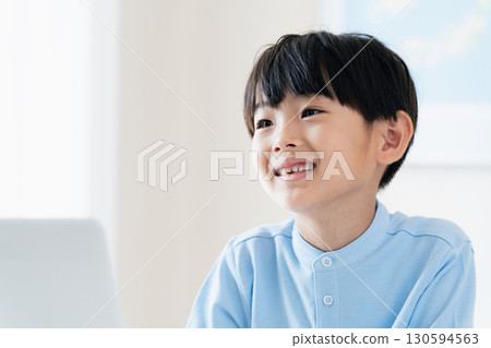 A boy taking a class in front of a computer A boy taking a class in front of a computer 130594563