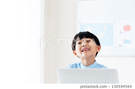 A boy taking a class in front of a computer A boy taking a class in front of a computer 130594564