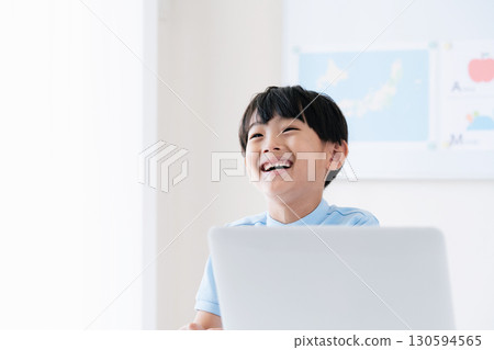 A boy taking a class in front of a computer A boy taking a class in front of a computer 130594565